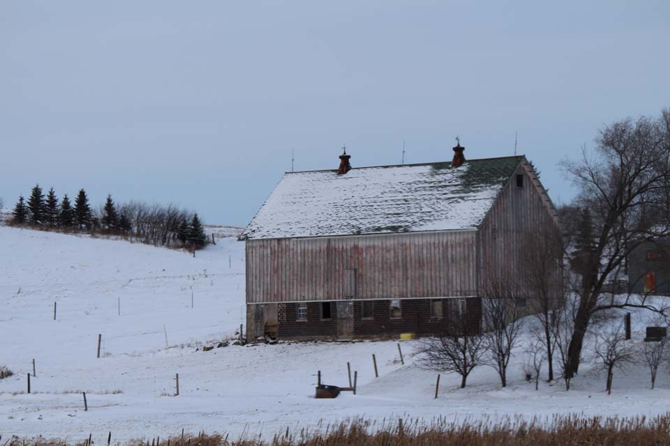snow covered rustic barn